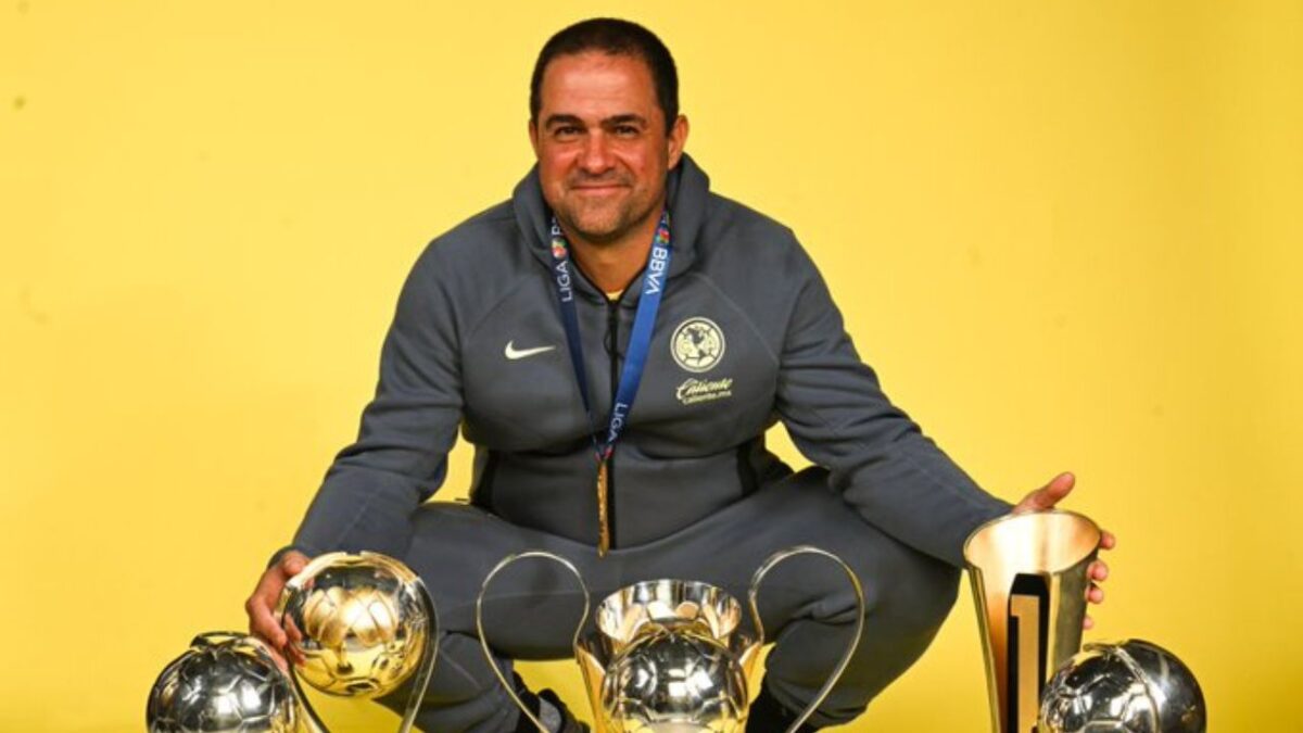 André Jardine, técnico del América, posando junto a los trofeos obtenidos en su gestión.